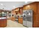 Charming kitchen boasts wood cabinets, stainless appliances, and tile flooring at 585 Summerhaven Dr, Debary, FL 32713