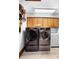Modern laundry room with new front loading washer and dryer, and ample storage at 585 Summerhaven Dr, Debary, FL 32713