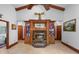 Elegant living room with vaulted ceiling, brick fireplace, and custom wood built-ins at 585 Summerhaven Dr, Debary, FL 32713