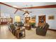 Spacious living room with tile floors, wood beams, and multiple seating areas for entertaining at 585 Summerhaven Dr, Debary, FL 32713