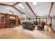 Cozy living room featuring a fireplace, wood beams, and comfortable seating arrangement at 585 Summerhaven Dr, Debary, FL 32713