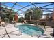 Sparkling pool in a screened lanai with dining and lounge areas for outdoor enjoyment at 585 Summerhaven Dr, Debary, FL 32713