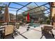 Screened-in lanai featuring a sparkling pool, lounge chairs, and patio furniture for outdoor relaxation and entertaining at 585 Summerhaven Dr, Debary, FL 32713