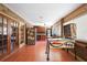 Versatile sun room featuring pinball machine, brick walls, tiled floor, windows, and plenty of natural light at 585 Summerhaven Dr, Debary, FL 32713