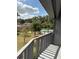 Private balcony boasts a view of the community pool and mature landscape, perfect for outdoor enjoyment at 600 N Boundary Ave # 114-C, Deland, FL 32720