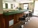 Cozy bar area features a long counter, wood paneling, and bar stools at 600 N Boundary Ave # 114-C, Deland, FL 32720