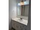 Bathroom vanity with a white sink, cabinets, mirror and three-light fixture at 600 N Boundary Ave # 114-C, Deland, FL 32720