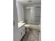 Bathroom with a shower and tub combo, vanity with storage, and neutral tile flooring at 600 N Boundary Ave # 114-C, Deland, FL 32720