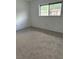 Bright and airy bedroom with neutral carpet, ample natural light from the window, ready for personalization at 600 N Boundary Ave # 114-C, Deland, FL 32720