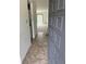 Inviting condo foyer with tiled flooring, with washer and dryer hookups, and view of the living area at 600 N Boundary Ave # 114-C, Deland, FL 32720
