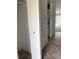 Condo hallway showing a storage closet, washer/dryer hookups, and leading into the main living area at 600 N Boundary Ave # 114-C, Deland, FL 32720