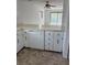 Eat in kitchen with white appliances, and view of the living space and balcony at 600 N Boundary Ave # 114-C, Deland, FL 32720