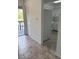 Condo kitchen with white appliances and tile floor, with view through a sliding door onto a balcony at 600 N Boundary Ave # 114-C, Deland, FL 32720