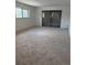 Spacious living room with neutral carpeting, ample natural light and access to a private outdoor space at 600 N Boundary Ave # 114-C, Deland, FL 32720