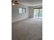 Bright living room features new carpeting, and a sliding glass door to a private outdoor space at 600 N Boundary Ave # 114-C, Deland, FL 32720