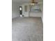 Neutral carpet creates a blank canvas in this living room next to a kitchen with white cabinetry at 600 N Boundary Ave # 114-C, Deland, FL 32720