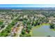 Stunning aerial view of home nestled next to a lake with a cityscape in the background at 61 Bryan Cave Rd, South Daytona, FL 32119