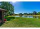 Expansive backyard featuring a serene lake view, providing a peaceful retreat at 61 Bryan Cave Rd, South Daytona, FL 32119