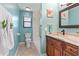 Well-lit bathroom featuring elegant wood vanity, marble countertops and tile floors at 61 Bryan Cave Rd, South Daytona, FL 32119