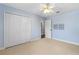 Bedroom with carpet floors, ceiling fan and large closet with plenty of storage space at 61 Bryan Cave Rd, South Daytona, FL 32119