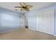 Bedroom with carpet floors, ceiling fan and large closet with plenty of storage space at 61 Bryan Cave Rd, South Daytona, FL 32119