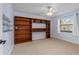 Bedroom with carpet floors, ceiling fan, built-in shelving and plenty of natural light at 61 Bryan Cave Rd, South Daytona, FL 32119