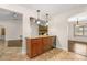 Open dining area with stone countertops, built-in cabinetry, and easy access to living and dining spaces at 61 Bryan Cave Rd, South Daytona, FL 32119