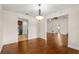 Open dining room with hardwood floors, stylish chandelier, and easy access to the kitchen at 61 Bryan Cave Rd, South Daytona, FL 32119