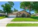 Charming brick home features a well-manicured lawn and an attached two-car garage at 61 Bryan Cave Rd, South Daytona, FL 32119