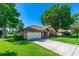 Charming brick home features a well-manicured lawn and an attached two-car garage at 61 Bryan Cave Rd, South Daytona, FL 32119