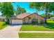 Charming brick home features a well-manicured lawn and an attached two-car garage at 61 Bryan Cave Rd, South Daytona, FL 32119