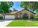Charming brick home features a well-manicured lawn and an attached two-car garage at 61 Bryan Cave Rd, South Daytona, FL 32119