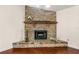 Close-up of brick fireplace with wooden mantle and decorative accents in a well-lit room at 61 Bryan Cave Rd, South Daytona, FL 32119