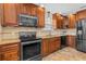 Renovated kitchen showcases modern stainless steel appliances, stone countertops and wooden cabinets at 61 Bryan Cave Rd, South Daytona, FL 32119