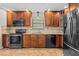 Well-equipped kitchen featuring stainless steel appliances, tiled backsplash, and wooden cabinets at 61 Bryan Cave Rd, South Daytona, FL 32119