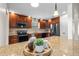 Kitchen island with granite countertop, and cabinetry, accessorized with plant, coffee cup, and bottle of coffee beans at 61 Bryan Cave Rd, South Daytona, FL 32119
