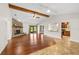 Open-concept living room features hardwood floors, brick fireplace, and views of backyard through sliding glass doors at 61 Bryan Cave Rd, South Daytona, FL 32119