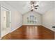 Bright main bedroom features vaulted ceiling, ceiling fan, hardwood floors, and a bathroom at 61 Bryan Cave Rd, South Daytona, FL 32119
