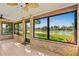 Beautiful sunroom with brick accents and expansive windows overlooking the serene lake at 61 Bryan Cave Rd, South Daytona, FL 32119