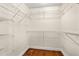 Walk-in closet with custom shelving and hardwood floors providing ample storage space at 61 Bryan Cave Rd, South Daytona, FL 32119