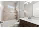 Bathroom with a tub, tile, mirror, vanity with sink, toilet, and wood cabinets at 617 Mosaic Blvd, Daytona Beach, FL 32124