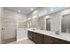 Modern bathroom features a double vanity sink, tiled shower, and large framed mirror above the sink at 617 Mosaic Blvd, Daytona Beach, FL 32124