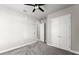 Bedroom with gray walls, gray carpet, with double doors and ceiling fan at 617 Mosaic Blvd, Daytona Beach, FL 32124