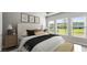 Bright bedroom with a cozy bed, plush pillows, framed art, and natural light from three windows at 617 Mosaic Blvd, Daytona Beach, FL 32124