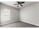 Bedroom with a gray wall, gray carpet, ceiling fan, and a window at 617 Mosaic Blvd, Daytona Beach, FL 32124