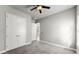 Empty room with gray carpet, white walls, ceiling fan, and lots of closet space at 617 Mosaic Blvd, Daytona Beach, FL 32124