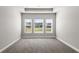 Bright, empty room with plush carpeting and natural light flowing through three large windows at 617 Mosaic Blvd, Daytona Beach, FL 32124