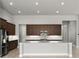 Modern kitchen with dark wood cabinets, granite countertops, and stainless steel appliances at 617 Mosaic Blvd, Daytona Beach, FL 32124
