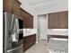 A modern kitchen features stainless steel appliances, granite countertops, and ample dark wood cabinetry at 617 Mosaic Blvd, Daytona Beach, FL 32124