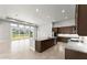 Open floor plan features a kitchen with granite countertops, a large island, and recessed lighting at 617 Mosaic Blvd, Daytona Beach, FL 32124